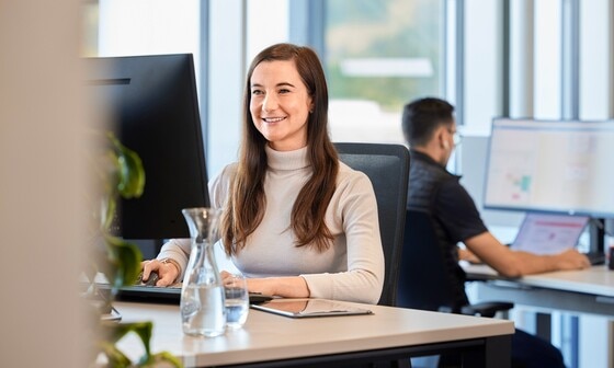 Uma especialista Blum trabalha no escritório em um PC.